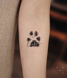 a dog paw print on the right arm and leg, with an animal's paw prints in black ink