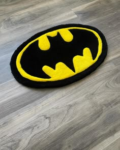 a batman rug is on the floor in front of a wooden floor with grey floors