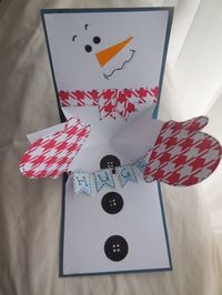 a snowman made out of paper and some scissors