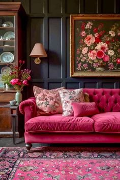 a living room with pink couches and rugs on the floor in front of a painting