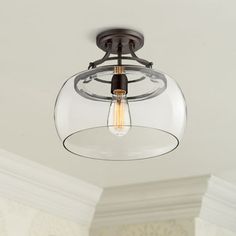 a light that is hanging from the ceiling in a room with white walls and ceilings