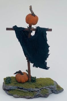 there is a fake scarecrow with two pumpkins on it