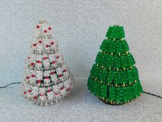 two small christmas trees made out of plastic beads