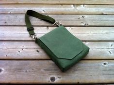 a green purse sitting on top of a wooden table