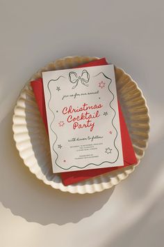 a paper plate with a card on top of it next to a red envelope that says christmas cookie party