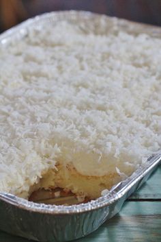 a metal pan filled with rice on top of a wooden table