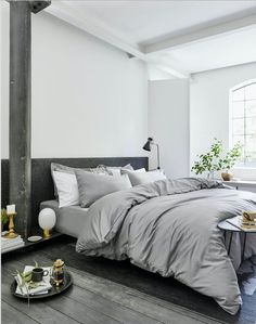 a bed sitting in a bedroom next to a table with a tray on top of it