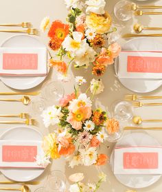 an overhead view of a table setting with place settings and flowers on the plateware