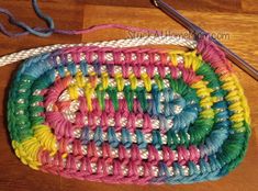 a crocheted purse is sitting on the floor