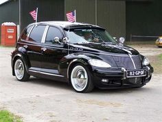 a black car parked in front of a building