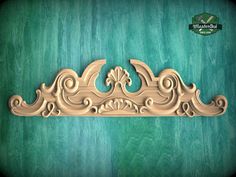 an ornate wooden carving on a green background