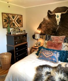 a large bear head mounted to the side of a wall above a bed in a bedroom