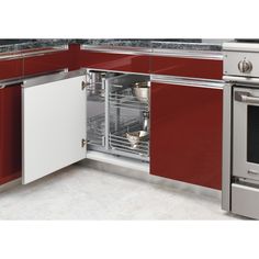 an open dishwasher in a kitchen with red cabinets and stainless steel appliances on the counter