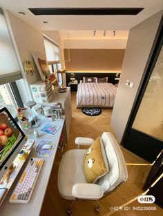 a room with a bed, desk and chair in it