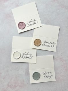 three different types of buttons on white envelopes