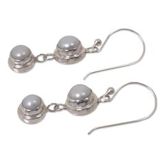 Silver moonlight radiates from luminous pearls, set in argent circles, they become dancing dangle earrings by Bali's Nyoman Rena. Pearls represent June´s birthstones. Sterling silver and freshwater cultured pearls Hook earrings Handmade in & fairly traded from Indonesia Silver Round Pearl Earrings As A Gift, Silver Pearl Charm Earrings, Nickel-free Adjustable Round Pearl Earrings, Silver Dangle Pearl Earrings For Anniversary, Silver Earrings With Pearl Charm, Adjustable Round Pearl Earrings For Anniversary, Adjustable Silver Pearl Drop Earrings, Silver Moonstone Jewelry With Pearl Drop, Silver Hypoallergenic Pearl Drop Earrings