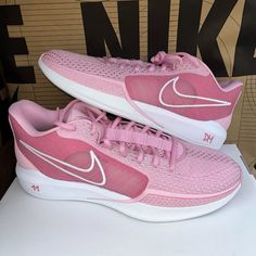 a pair of pink and white nike shoes