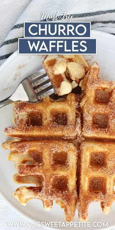 a white plate topped with waffles covered in powdered sugar next to a fork