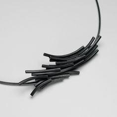 Created exclusively for Aosdàna by Scottish artist, Beth Legg, this necklet is based on the basalt rock structures of Staffa. The design echoes the hexagonal columns of the island and depict the beautiful curves and sense of movement found in the rock structures which were created when cooling flows of lava came into contact with the bedrock. From our workshop and studio at the St. Columba Steadings on the Isle of Iona, Aosdàna continues to use the same techniques as earlier Iona silversmiths to craft the original designs that have remained so popular over the years. Each piece is hand finished and reflects the care and attention only fitting to the historical legacy of the island's craftsmen and women. Modern Oxidized Finish Formal Necklace, Contemporary Black Jewelry With Oxidized Finish, Modern Black Necklace With Oxidized Finish, Isle Of Iona, St Columba, Basalt Rock, Unique Symbols, Scottish Artists, The Isle