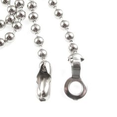 a silver ball and chain necklace on a white background with clippings to the clasp