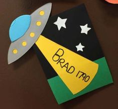 a paper craft with the name brad tro written on it and a rocket ship