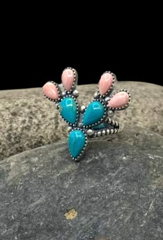 Signed Navajo Sterling Silver Turquoise Pink Conch Shell Multi Stone Cactus Ring 7.25 Orders totaling $100 and up include an anti-tarnish treated velvet jewelry pouch!  Ring is a size 7.25 Face of ring measures approximately 1.25" X 1.5" Weighs approximately 10 grams Condition: New Metal: Sterling Silver See photos for hallmark Comes in a gift box  This item is in used condition and will exhibit the expected surface scratches and dings to the silver from normal wear.  Take a look at our other ri Conch Ring, Stone Cactus, Cactus Ring, Western Clothes, Turquoise Jewelry Native American, Navajo Rings, Velvet Jewelry, New Metal, Conch Shell