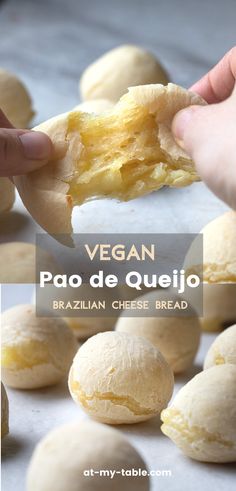 a person holding a piece of bread in their hand with the words vegan pao de quejo on it