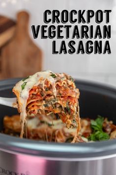 the crockpot vegetarian lasagna is being lifted from the slow cooker