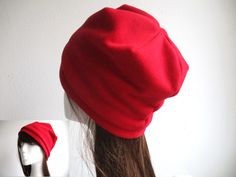 a woman's red hat on top of a mannequin head with long hair