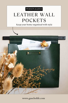 a green leather wall pocket with the text personalized on it and some dried flowers