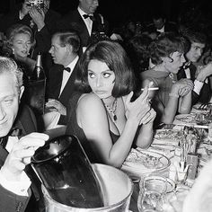 a group of people sitting at a dinner table