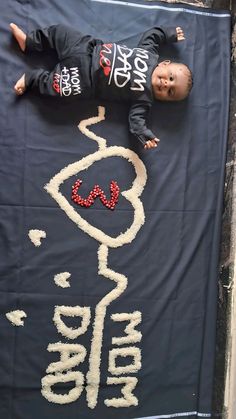 a baby laying on top of a large sign