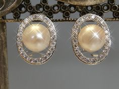 A fine pair of solid silver oval set pearl and cubic zirconia earrings, the pearl is set central and set in an open work design with a border set with clear cubic zirconias that sparkle like real diamonds. would make lovely wedding earrings, or just a lovely classic setting for everday wear. have post and omega hinged fittings for safe wear, stamped 925 for silver. Wedding Sterling Silver Clip-on Pearl Earrings, Luxury Silver Clip-on Pearl Earrings, Nickel-free Sterling Silver Pearl Earrings For Anniversary, Nickel-free Sterling Silver Pearl Earrings For Party, Silver Cubic Zirconia Pearl Earrings, Round Cut, Set Earrings, Work Design, Cubic Zirconia Earrings, Zirconia Earrings