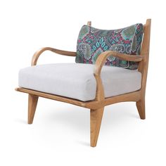 a wooden chair with a patterned pillow on it's back and armrests