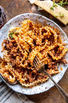 a white plate topped with pasta and meat