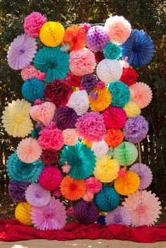 colorful paper flowers arranged in the shape of a heart