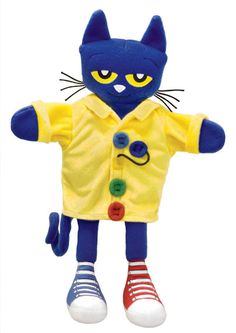 a blue and yellow cat stuffed animal wearing a yellow shirt with buttons on it's chest