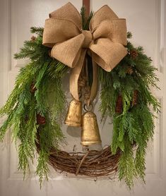 a wreath with bells hanging on the front door