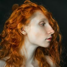 a woman with red hair is posing for the camera