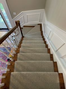 a staircase with carpeted steps leading up to the second floor