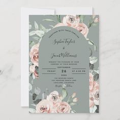 a wedding card with pink roses on the front and green leaves on the back, sitting on top of a marble surface