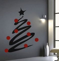 a wall decal with a christmas tree in the center and red balls around it