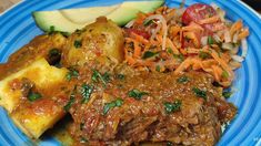 a blue plate topped with meat and veggies next to an eggplant