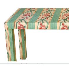 a small table with an ornate design on it's top and bottom edge, sitting in front of a white background