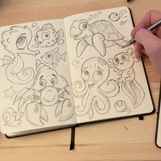 someone is drawing some cartoon characters on their notebook