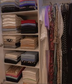 the closet is full of clothes and folded shirts