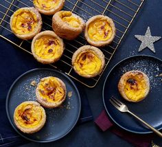 several small pastries sitting on top of blue plates next to a star shaped cookie