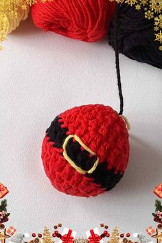 a red ball of yarn sitting on top of a table