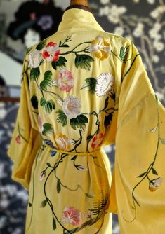 Oh what a beauty!! Such a great colour for summer! This dates to the later 1930s and has bold silk hand embroidery of big blooms and trailing foliage. It is fully lined in soft yellow silk and comes with a matching rope belt with tassels. It does have the odd mark as photographed, which may lift with a gentle sponging. The most evident is that to the nape. It is however, structurally sound and the embroidery is in good order. Photographed on my UK size 8 mannequin. Back of shoulders 26" Nape to hem 51.5" Spring Silk Kimono With Floral Embroidery, Spring Silk Kimono With Embroidery, Spring Embroidered Silk Kimono, Vintage Floral Print Kimono For Wedding, Vintage Spring Wedding Kimono, Vintage Kimono With Floral Embroidery, Embroidery Kimono, Rope Belt, Yellow Silk