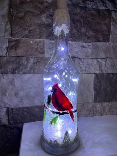 a lighted bottle with a cardinal on it